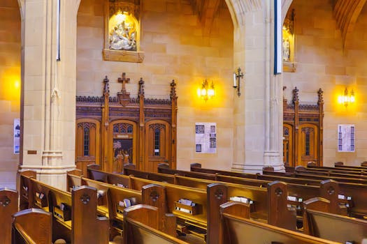 Beautiful church interior featuring wooden pews and ornate wooden carvings.